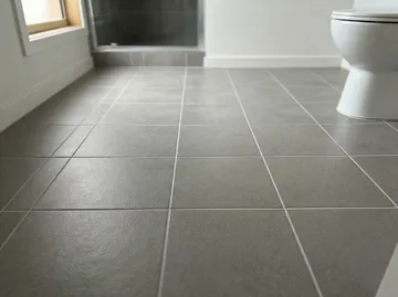 Grey bathroom floor tiles with clean pale grout lines